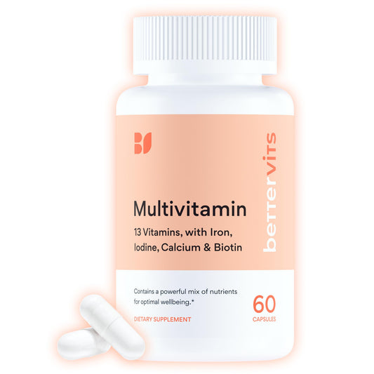 Multivitamin supplement bottle with white capsules on a light pink background